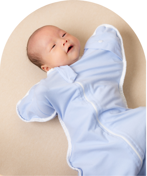 baby lying in cot smiling